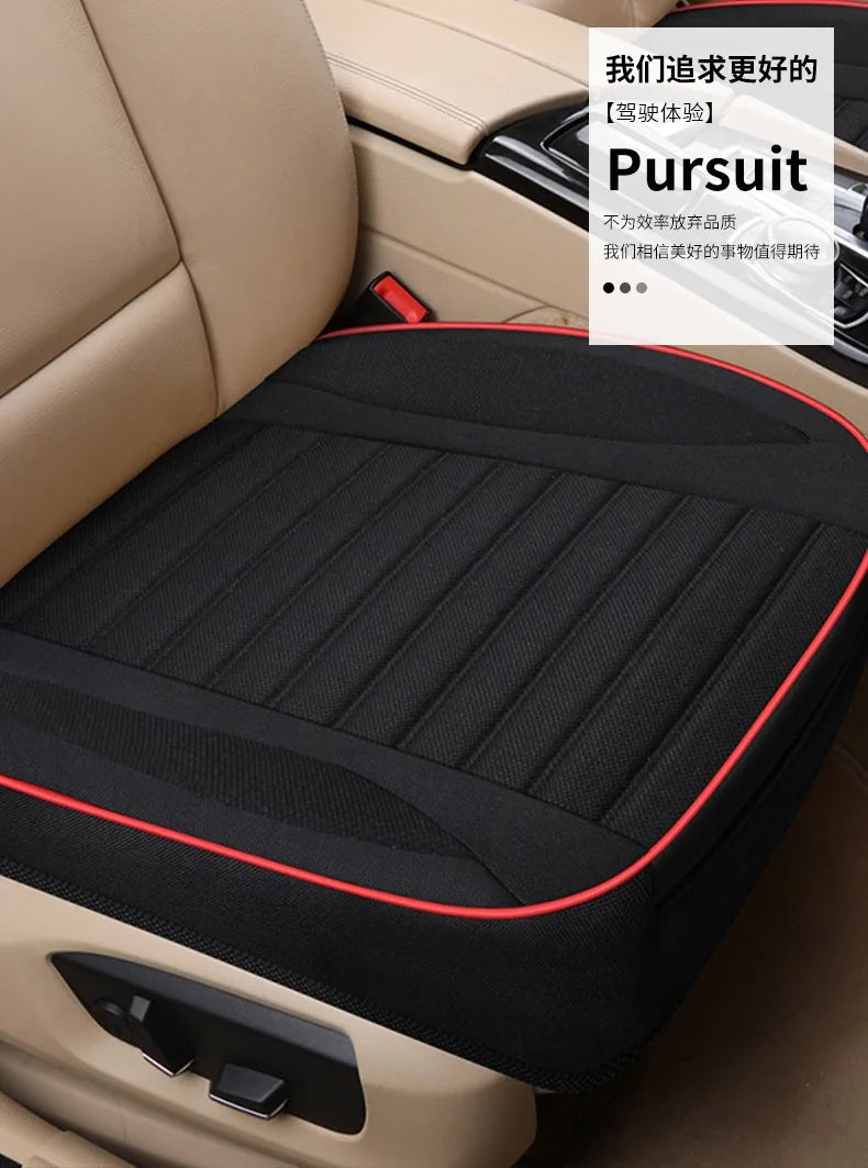 Black padded car seat covers installed in a beige vehicle interior.