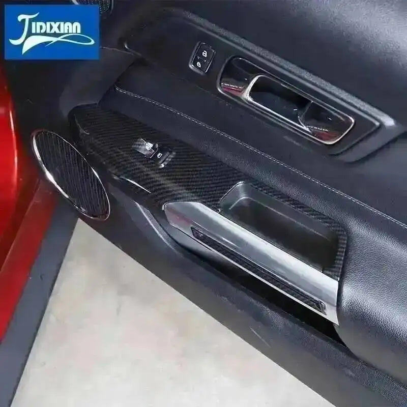 Interior decoration kit for a car featuring a carbon fiber trim piece and a silver accent panel.