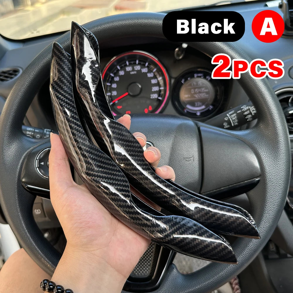 Black universal car steering wheel booster cover with carbon fiber pattern shown on a car steering wheel.