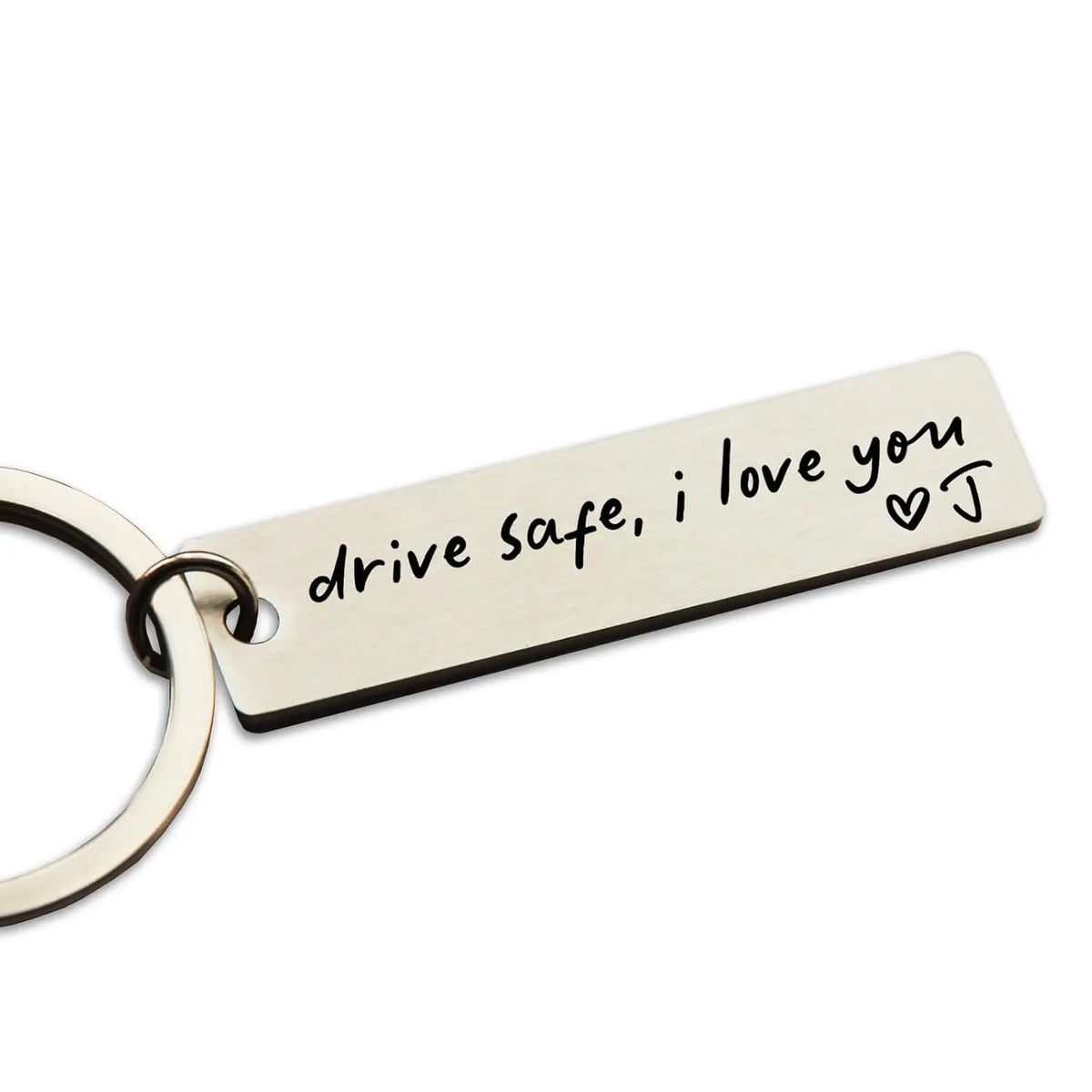 A stainless steel keychain tag engraved with the message drive safe i love you and a heart symbol.