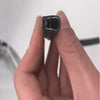 A hand holds a black rubber edge seal trim for vehicle doors and windows.