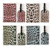A collection of five leopard print passport holders in various shades and finishes.