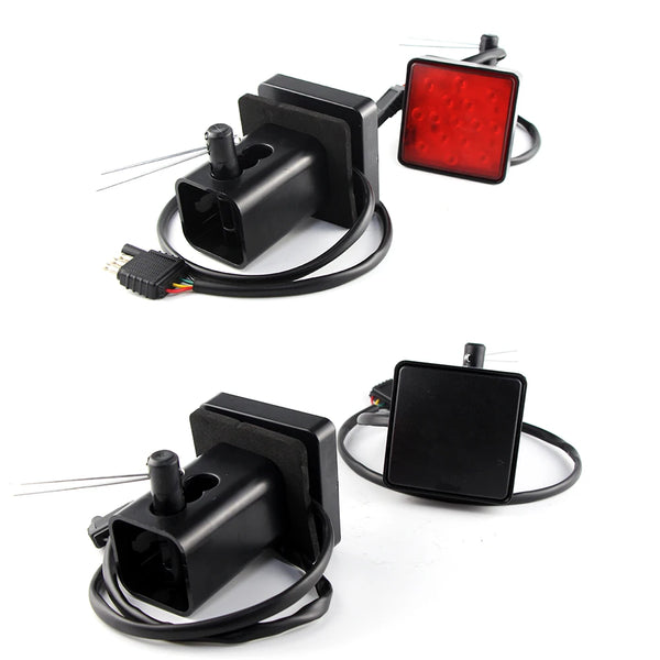 A black LED trailer hitch light cover with a red illuminated light and electrical connector cable.
