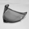 A clear motorcycle helmet visor with a dark tint is shown from a slight angle.