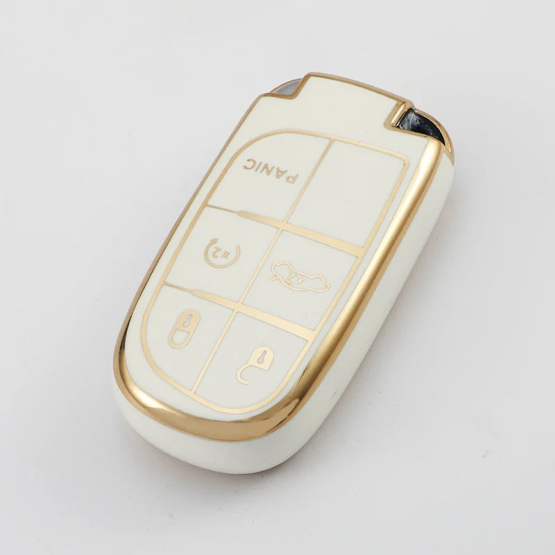 A white and gold TPU car key case cover with four labeled buttons for multiple vehicles.