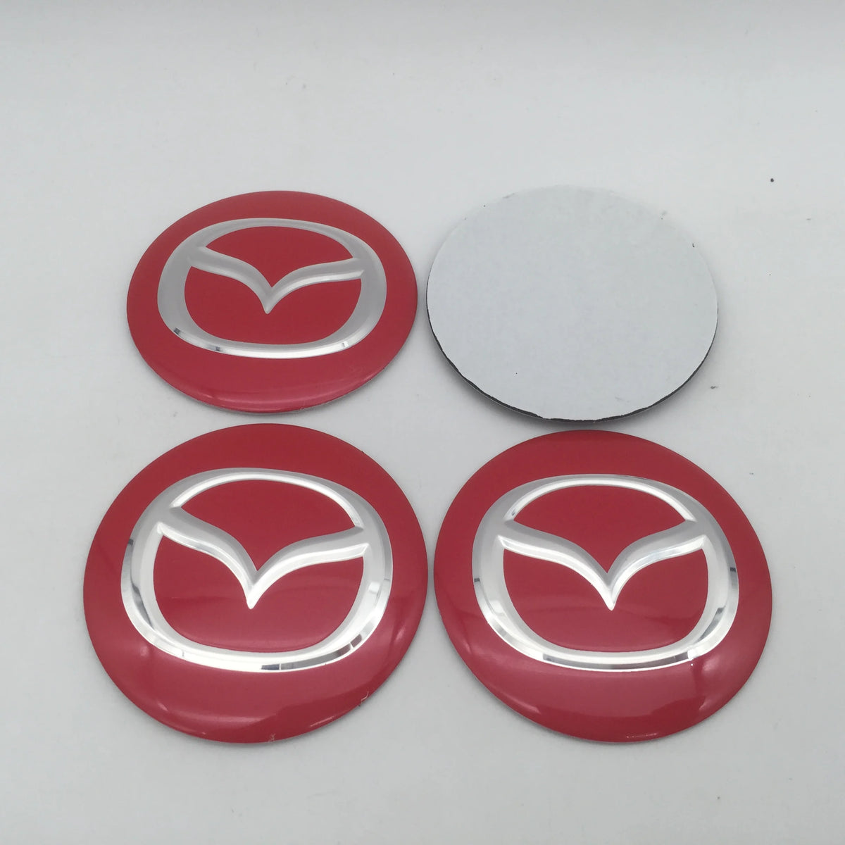 Four red and silver 3D car wheel hub center cap decals for Mazda models