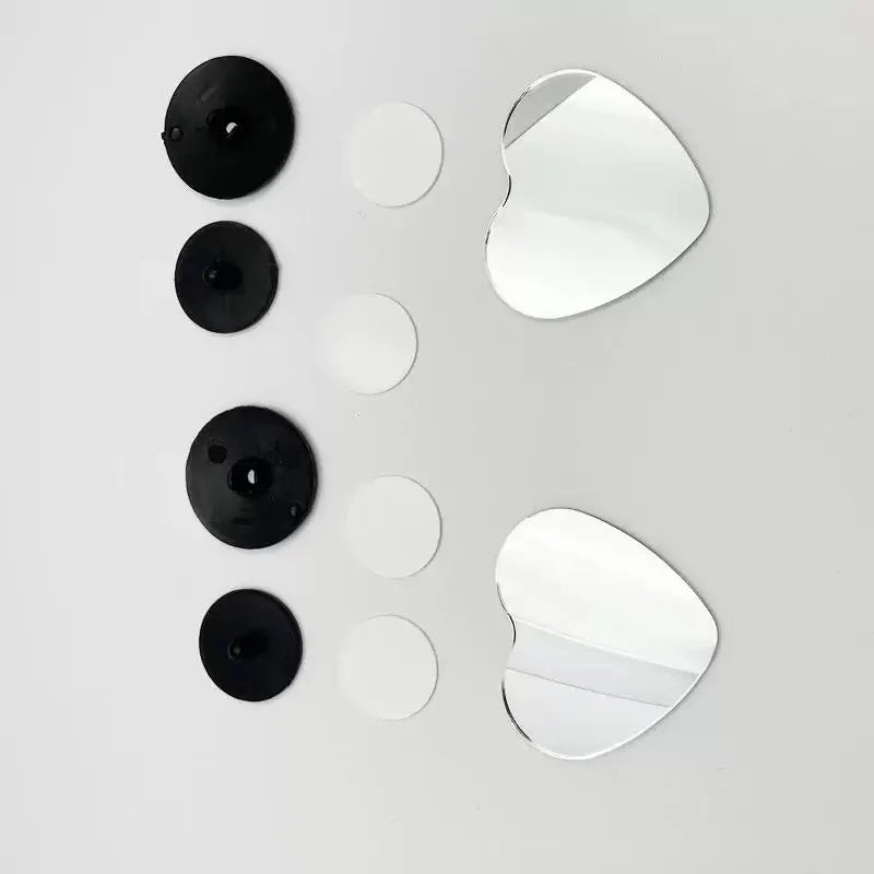 A set of five heart-shaped car rearview mirrors in black and silver.