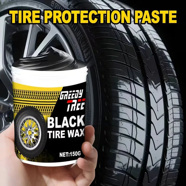 A hand holds a container of Greedy Tree Black Tire Wax for tire protection against a black tire.