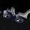 Wireless LED projector lights the floor with a Citroën logo design near a car door.