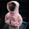 A light pink cozy knit gear shift cover for a manual transmission is shown in a close-up view.