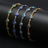 Gold plated evil eye charm bracelet featuring blue and white circular charms on an adjustable link chain