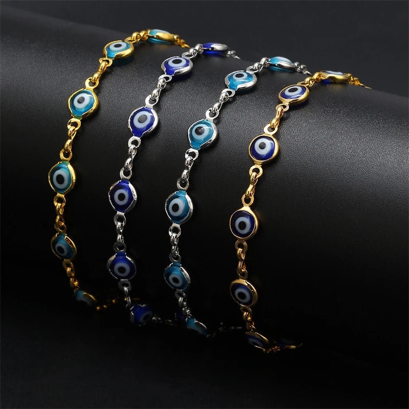 Gold plated evil eye charm bracelet featuring blue and white circular charms on an adjustable link chain