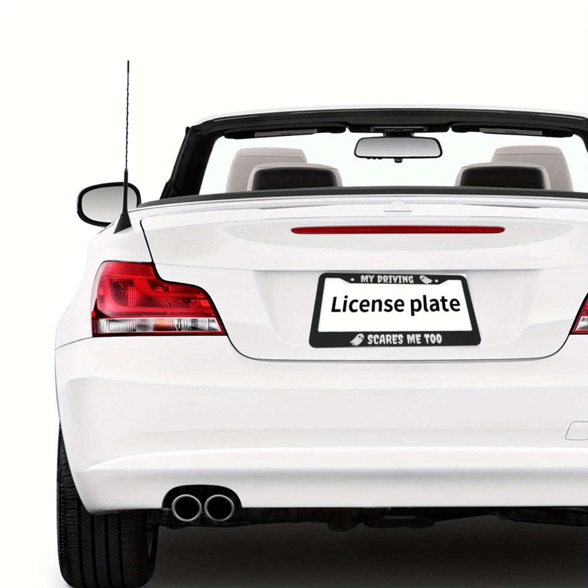 A white car with an aluminum license plate frame displaying the text Scares Me Too.