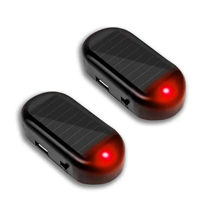 A black solar powered anti-theft car warning light with a red lens.