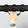A hand grips a black roll bar grab handle on a vehicle.