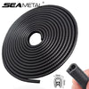 Roll of black U-shape car door edge protector trim with a 6mm thickness and 10mm length shown in a coil.