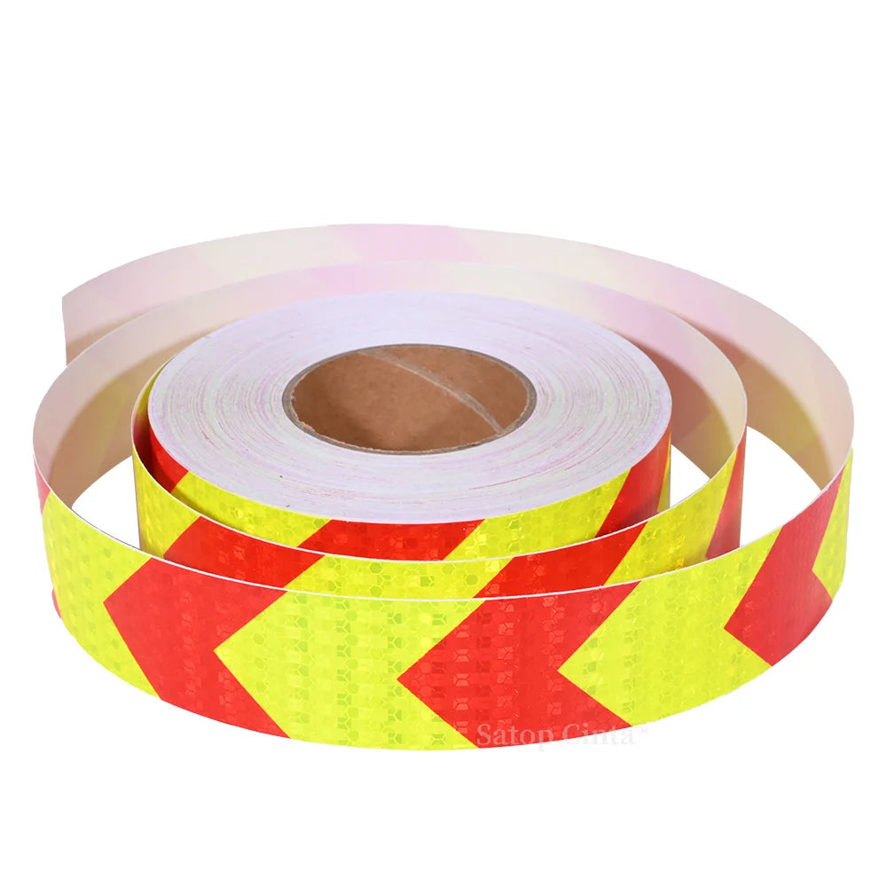Roll of yellow and red high-visibility fluorescent reflective safety tape on a spool