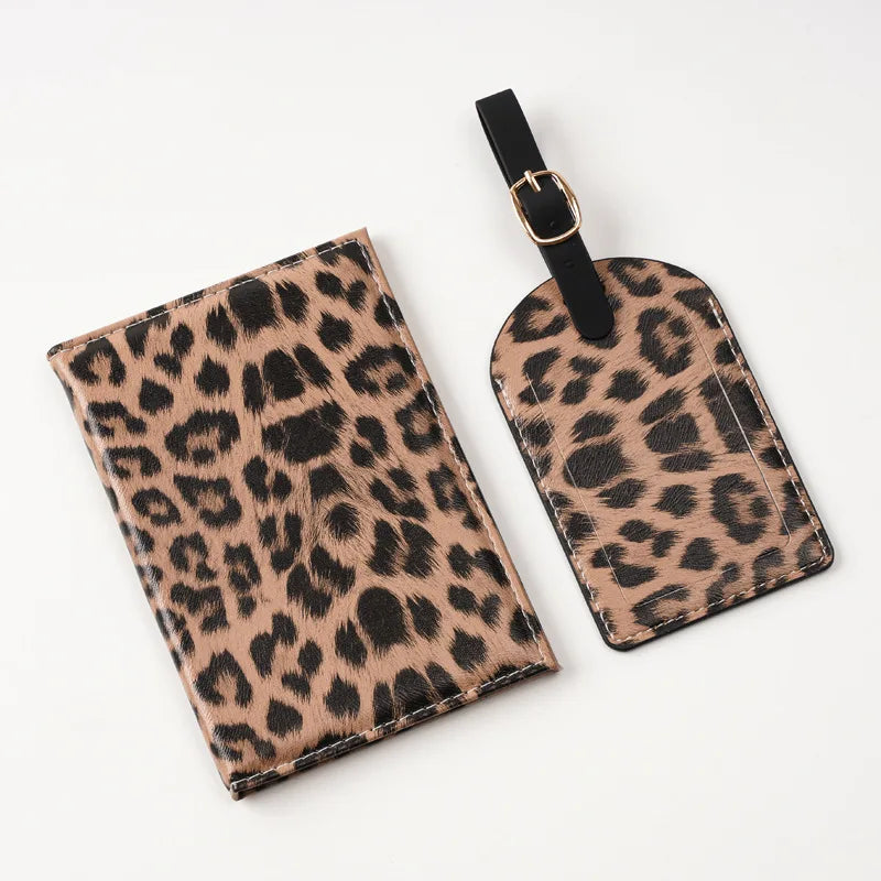 A black and tan leopard print passport holder with card slots attached to a black strap.
