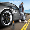 A man is using a portable digital tire inflator device near a silver Porsche, demonstrating an auto shut-off feature.