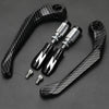 A set of black carbon fiber motorcycle levers and handguard protectors displayed on a dark background.