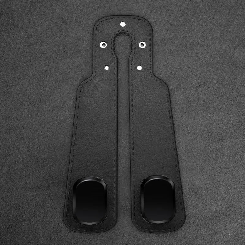 A pair of black universal car headrest hooks for storage organization, featuring leather-like material and metal attachments.