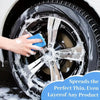 A hand applies a cleaning product to a black car wheel using a blue microfiber pad.
