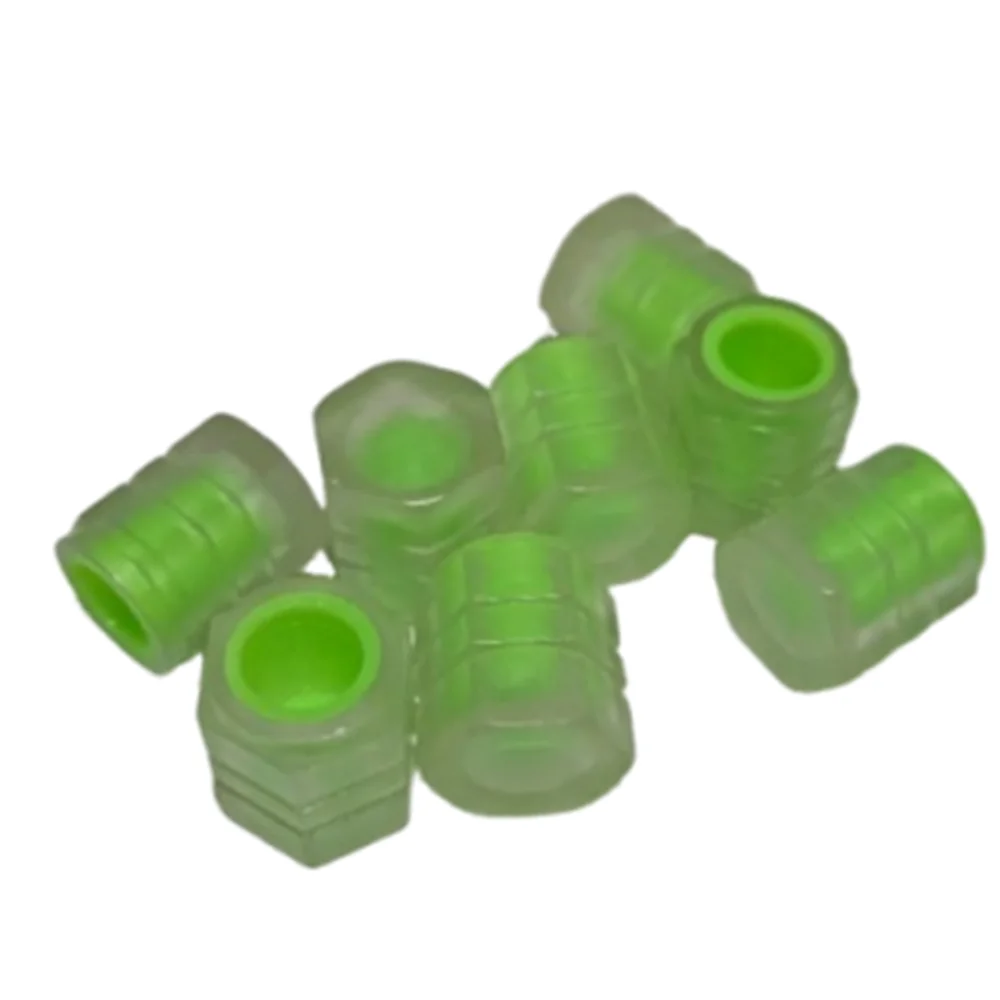 A collection of translucent green self-luminous tire valve caps.
