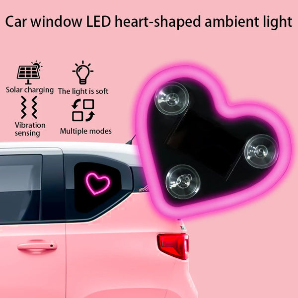 A heart-shaped LED ambient light is installed in a car window, featuring solar charging and vibration sensing.