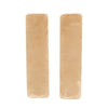 Two beige luxury car seatbelt shoulder pads displayed side by side.