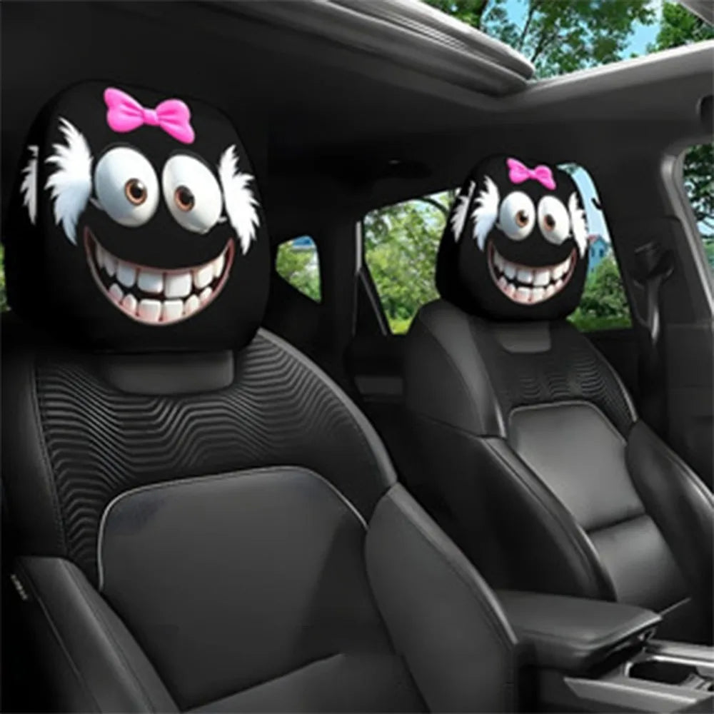 Black car seat headrest covers featuring decorative smiling faces with pink bows