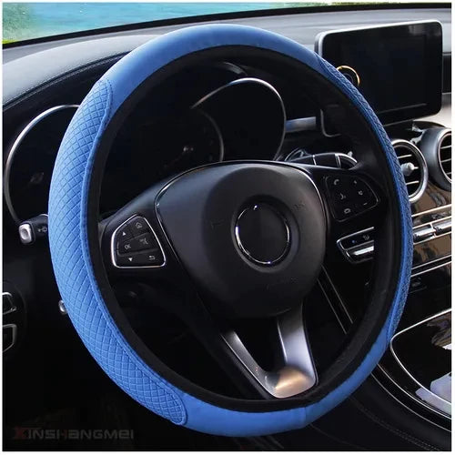 A close-up view of a blue anti-slip leather steering wheel cover inside a car's interior.