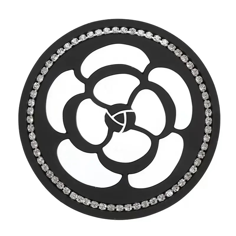 A black silicone car cup coasters set with a floral design and clear crystal accents.