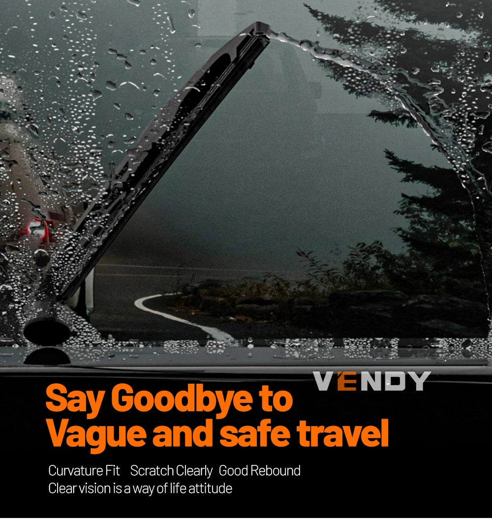 Close-up of a windshield with water droplets showing a clear view of a road and trees.
