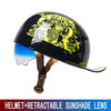 Black retro half helmet with a yellow and green graphic featuring a lion's head and a retractable sunglass lens.