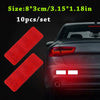 Ten sets of red reflective safety strips for vehicles shown next to a dark car body.