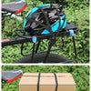 A black and blue helmet is secured on a motorcycle rack using a heavy duty seat strap kit.