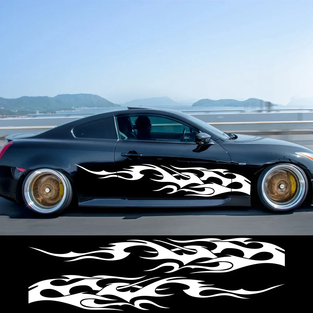 A black sports car with flame vinyl decals on the side, viewed from the side.