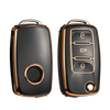 A pair of black TPU car key covers with copper accents shown against a black background.
