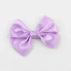 A lilac silk hair bow tied in a classic bow shape.