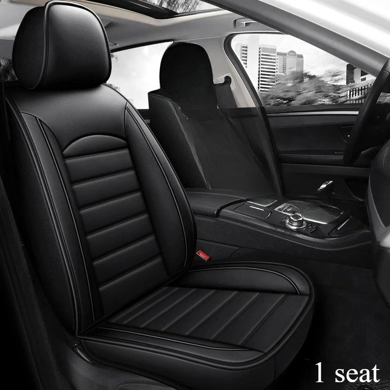 Interior view of a black car seat with full coverage leather seat covers in a vehicle cabin.