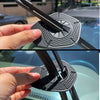 A hand is installing anti-leak wiper arm hole covers onto a car windshield.