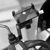 A black universal phone holder is mounted on a bicycle handlebar, designed for use with motorcycles and bicycles.