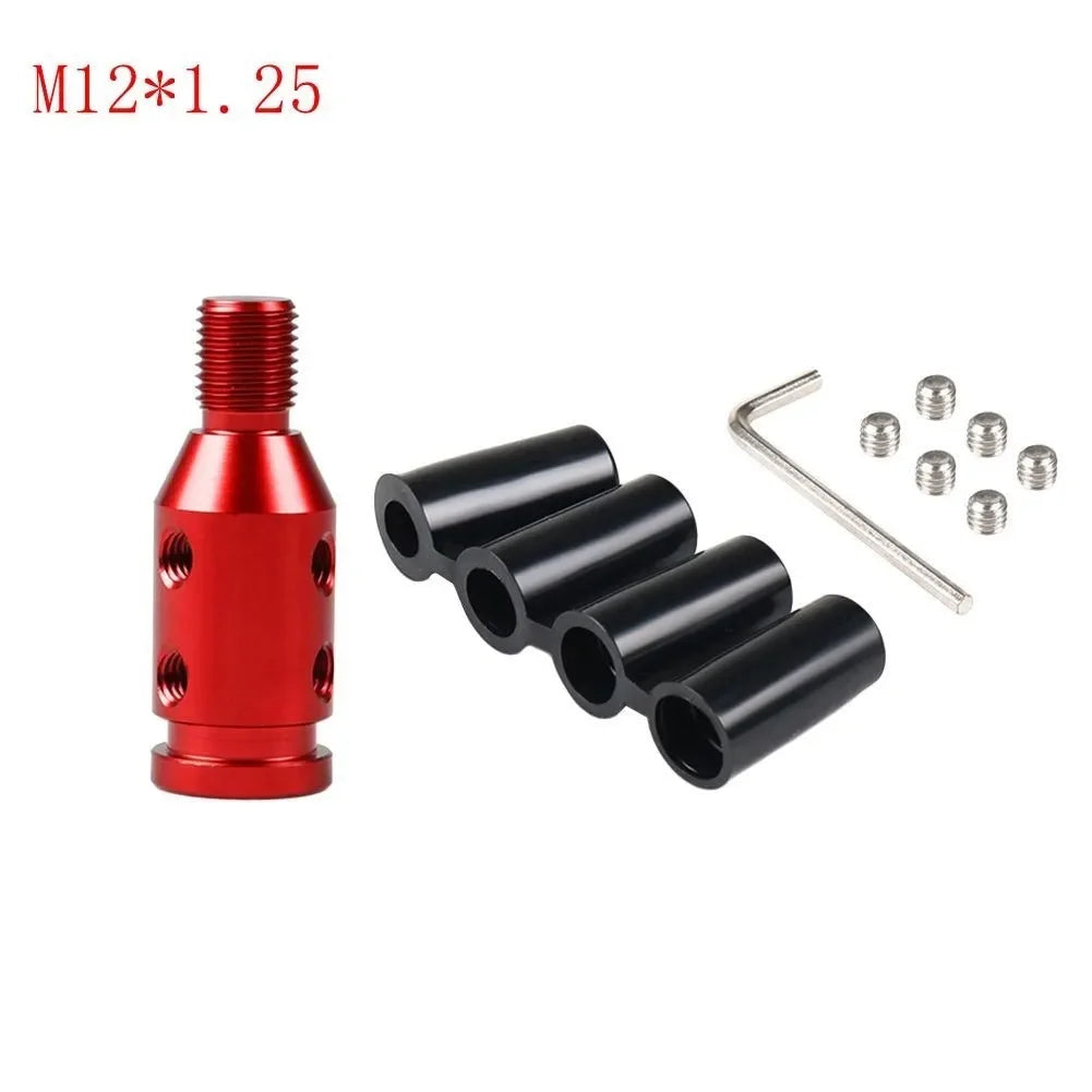 A red and black gear shift knob adapter with a threaded top and several cylindrical adapters for manual transmission.