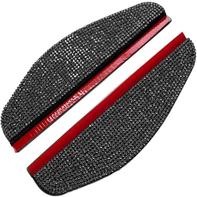 A pair of black rhinestone car rain shield visors with red trim.