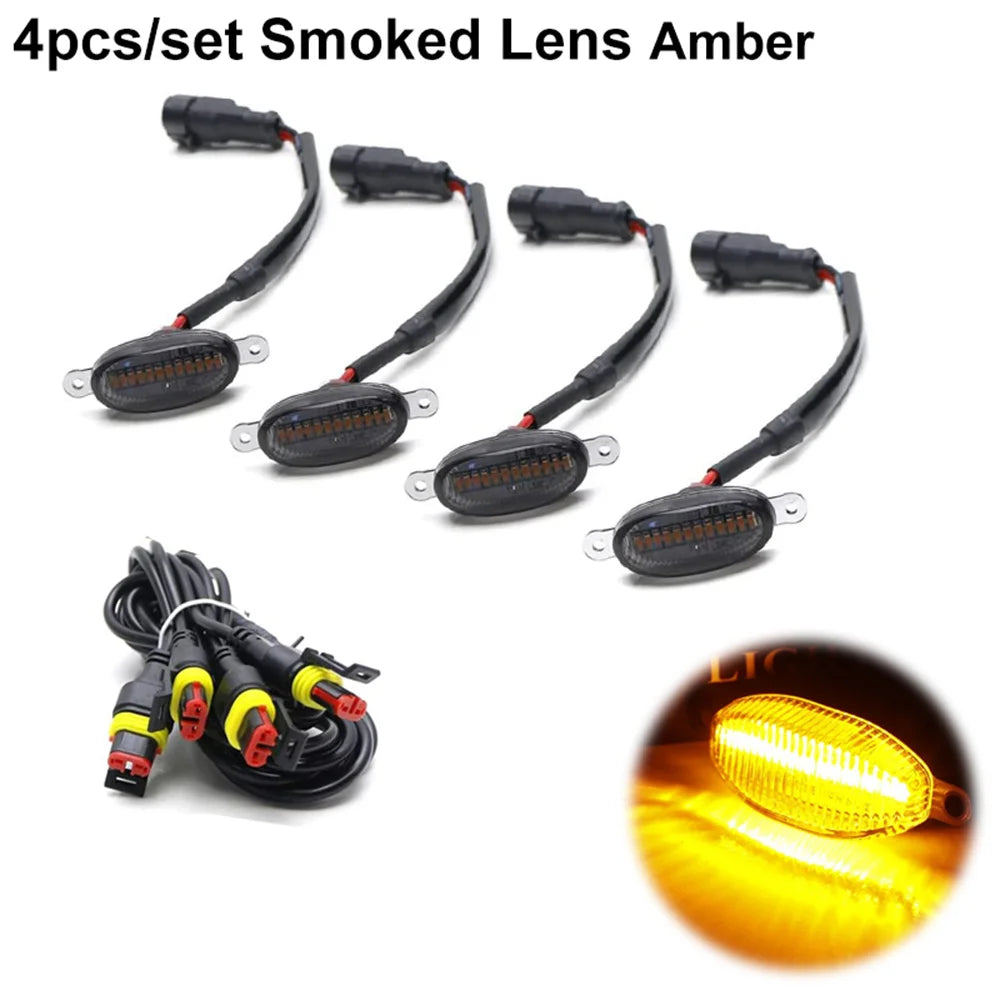 Cuatro juegos de luces indicadoras LED ámbar de lente ahumado para parrillas de camionetas y SUV con arneses de cableado.