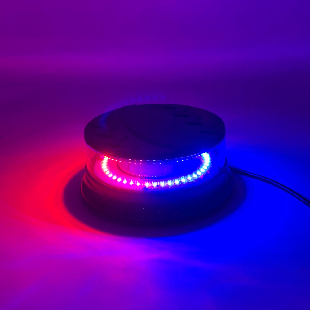 An emergency LED strobe light emitting bright red and blue light against a dark purple background.