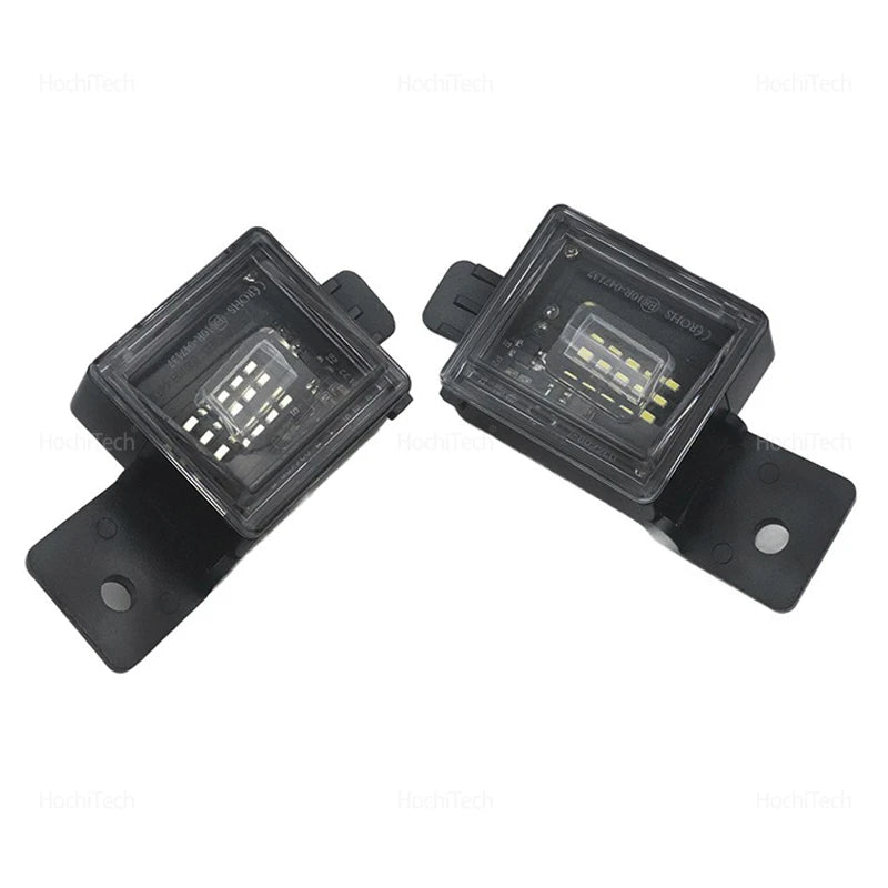A pair of black LED license plate lights for Chevy Silverado, GMC Sierra, and Canyon trucks.
