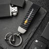 A close-up of a luxury metal Chevrolet key ring set resting on a dark surface.