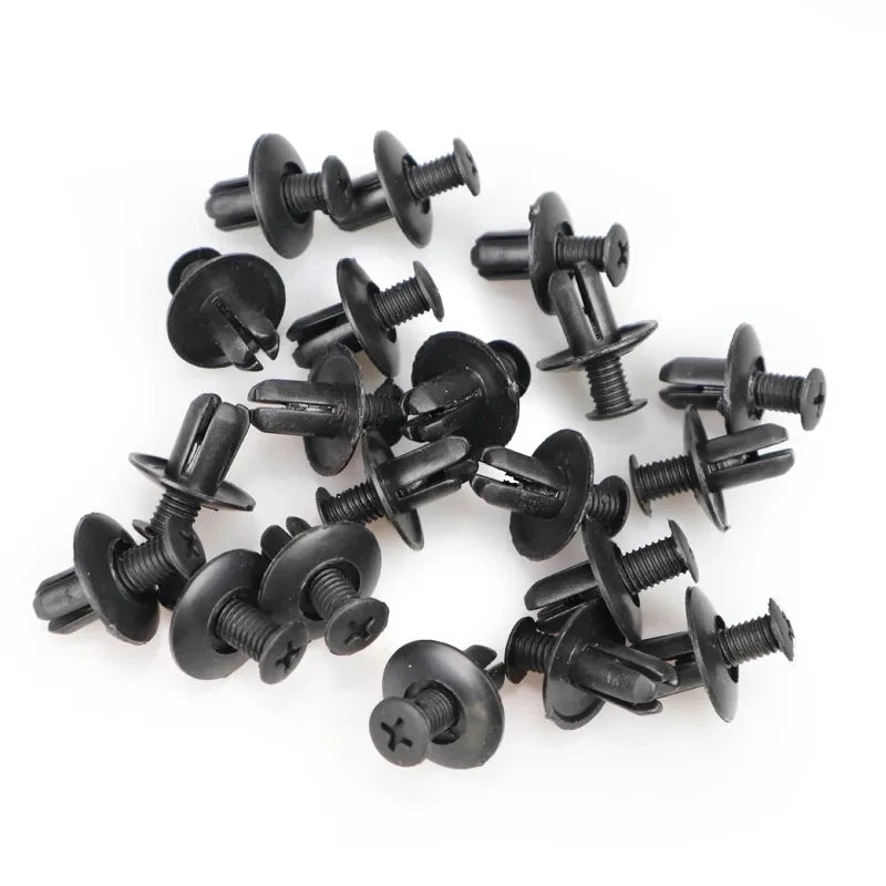 A collection of black plastic fasteners used for vehicle trim.