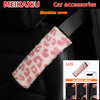 Pink leopard print plush shoulder cover installed on a black car seat.